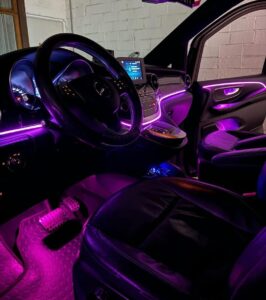 Shows a mercedes van with pink LED lights