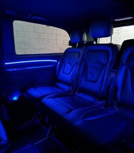 Shows a mercedes van back seats with blue LED lights