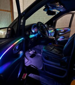 Shows a mercedes van with colorful LED lights