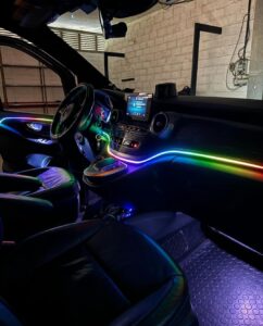 Shows a mercedes van with colorful LED lights